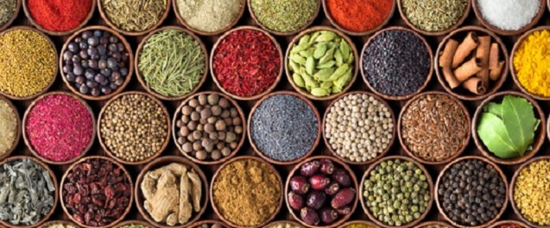 Different seasonings in cups. Spice background on the table